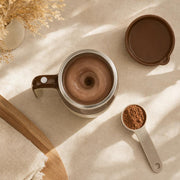 Top view of a chocolate shake swirling in the cream & coffee mug